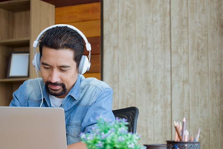 man listening to music while working